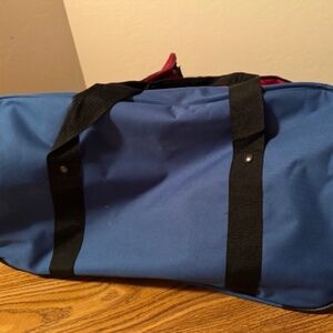 New   Blue duffel bag zip and shoulder strap .
